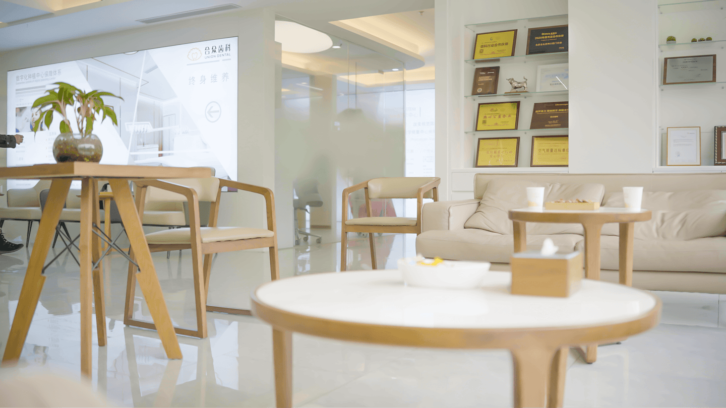 Modern professional waiting room with chairs and a beige sofa.